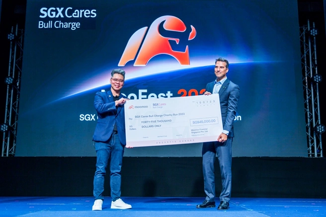 Figure 1 Our CEO Gavin Chia presenting a cheque to Mr Pol de Win of SGX
